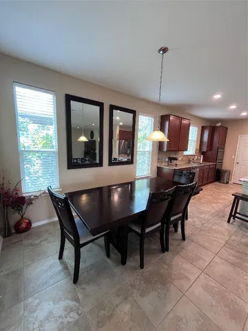 a living room with furniture a window and a flat screen tv