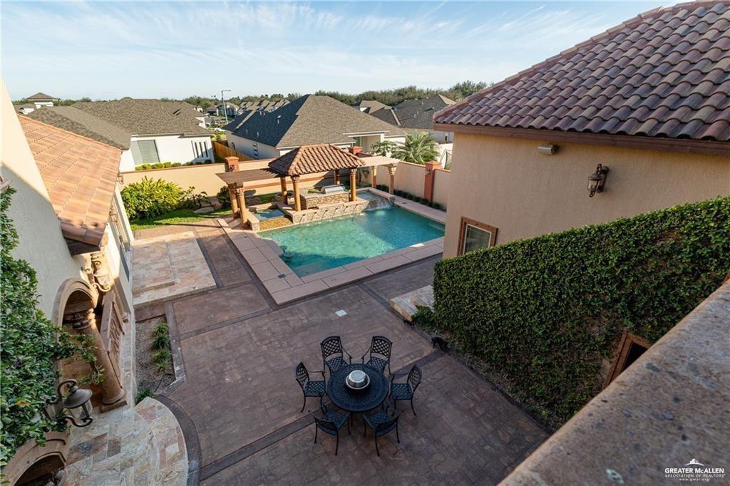1205 Travis Street Mission, TX 78572 - Photo 34 of 45 a view of a patio with table and chairs under an umbrella