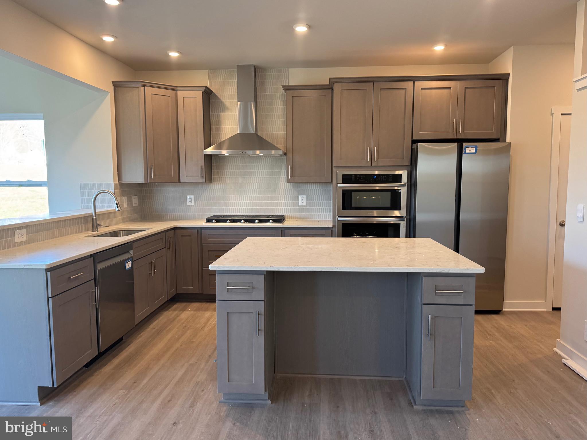9076 Bell Mare Lane Rixeyville, VA 22737 - Photo 2 of 9 a kitchen with kitchen island a sink stainless steel appliances and cabinets