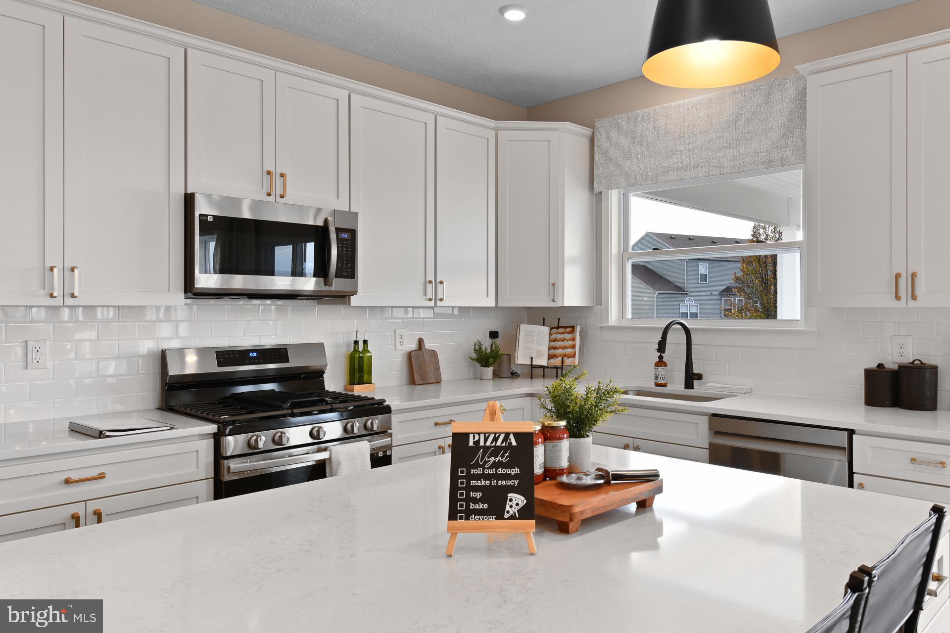 9076 Bell Mare Lane Rixeyville, VA 22737 - Photo 3 of 9 a kitchen with stainless steel appliances a stove a sink and a white cabinets
