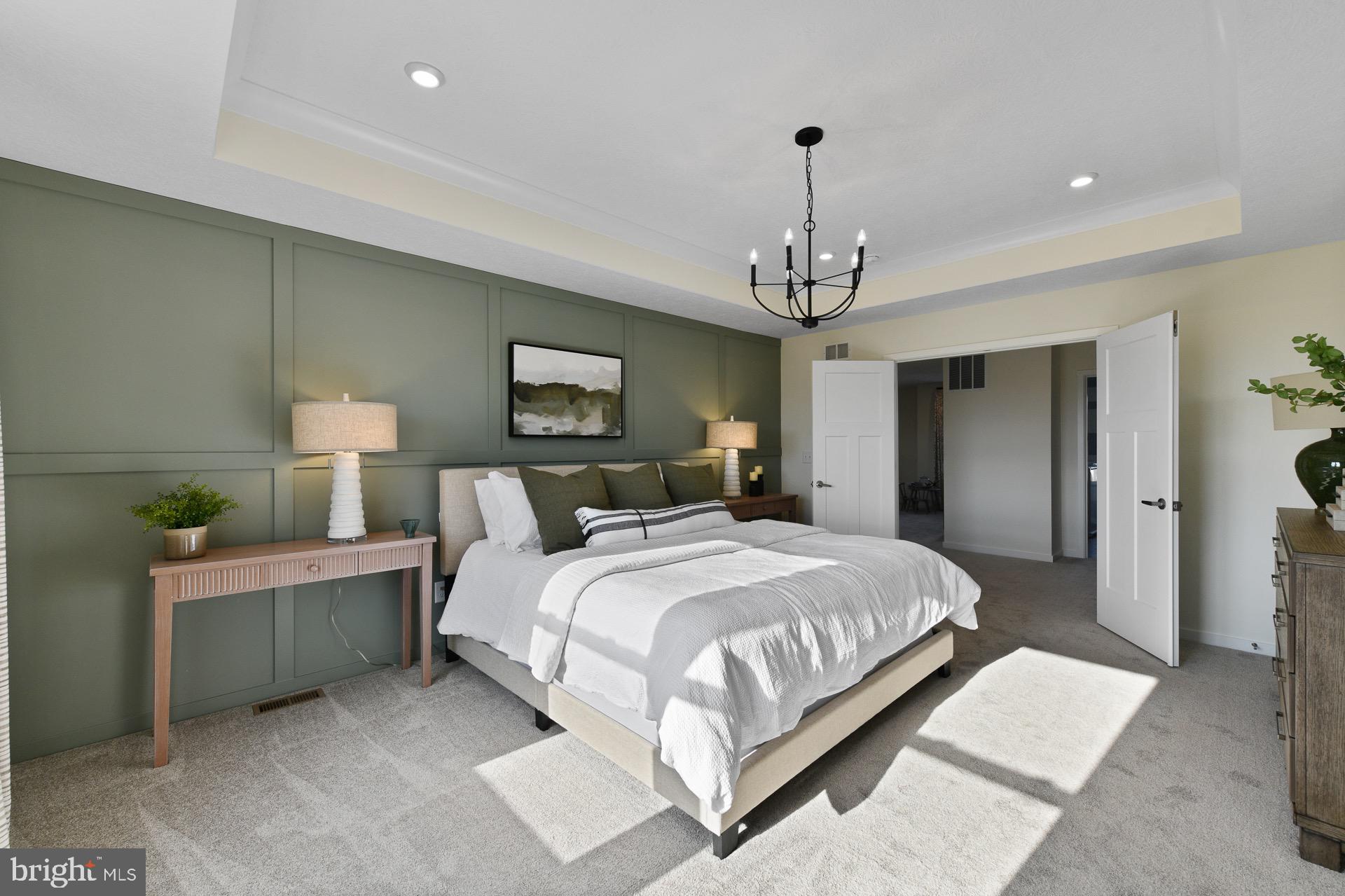 9076 Bell Mare Lane Rixeyville, VA 22737 - Photo 4 of 9 a spacious bedroom with a bed and a chandelier