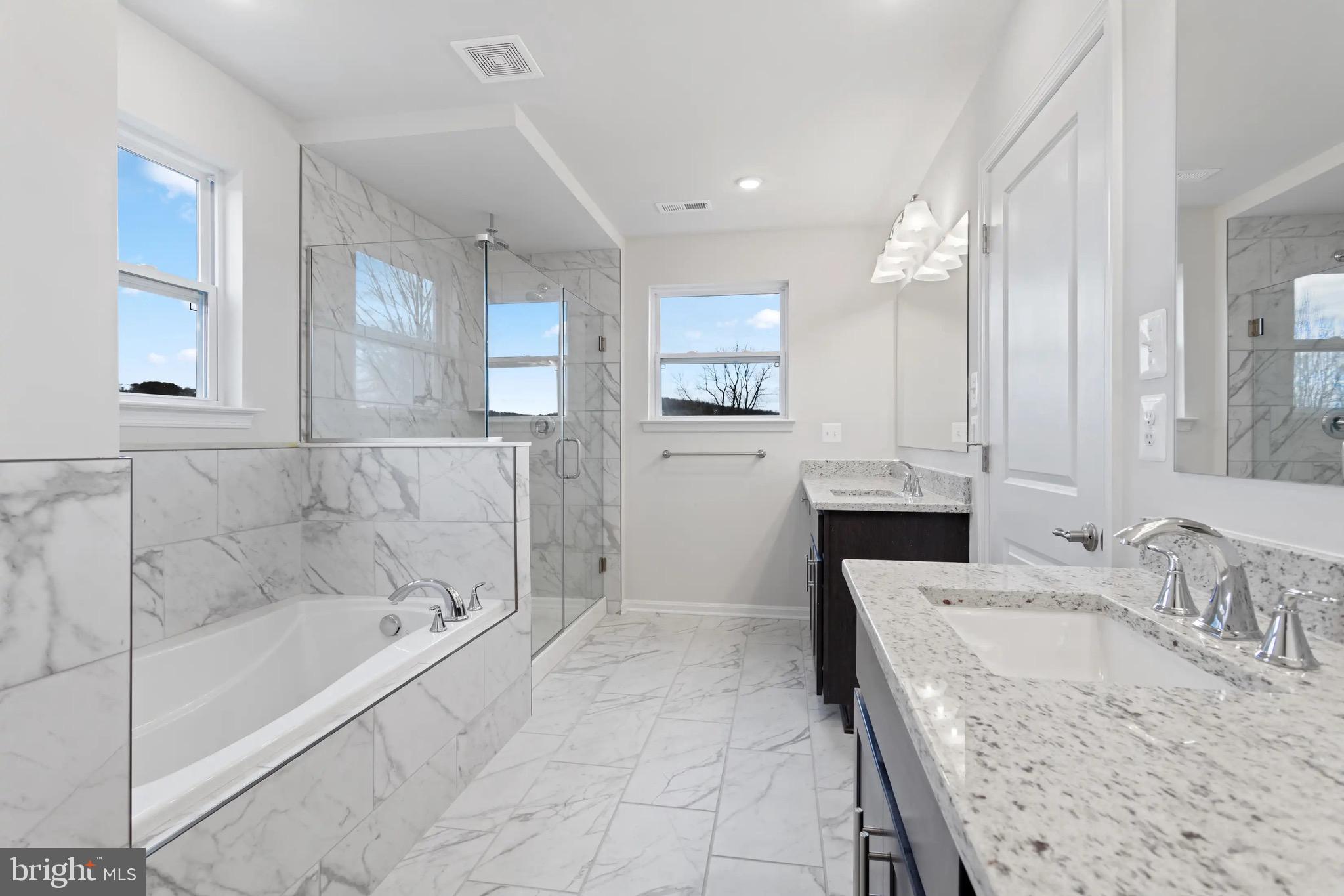 9076 Bell Mare Lane Rixeyville, VA 22737 - Photo 6 of 9 a bathroom with a granite countertop tub sink shower and mirror