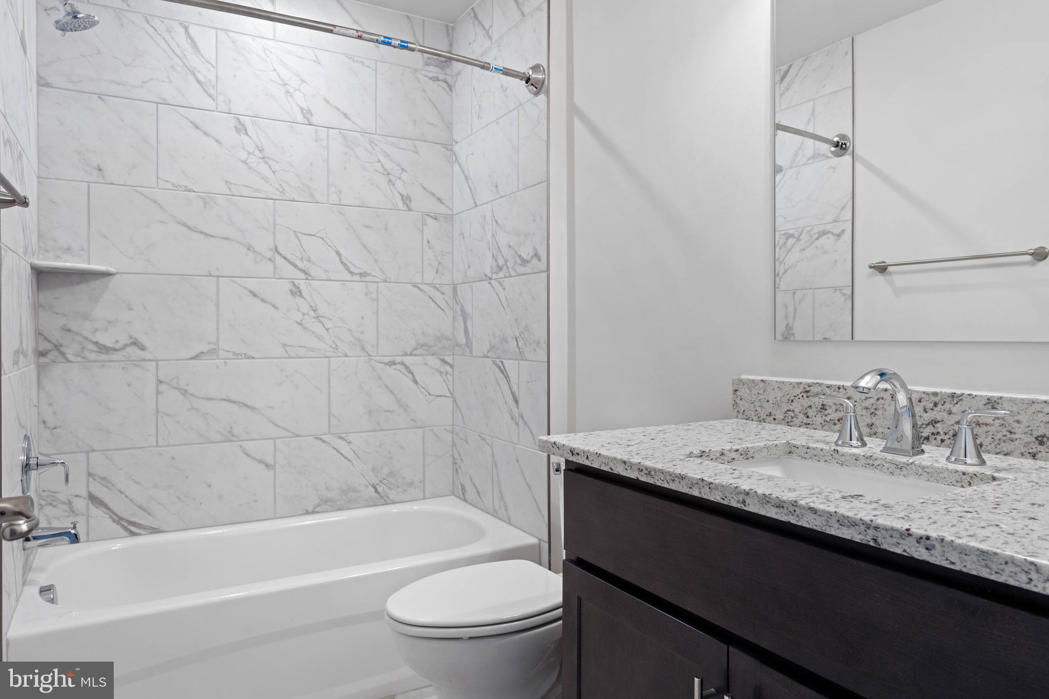 9076 Bell Mare Lane Rixeyville, VA 22737 - Photo 7 of 9 a bathroom with a granite countertop sink toilet and shower