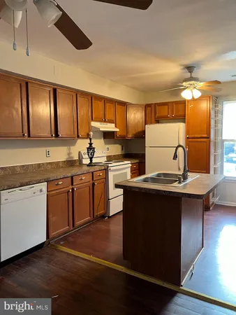 a kitchen with a sink cabinets and window