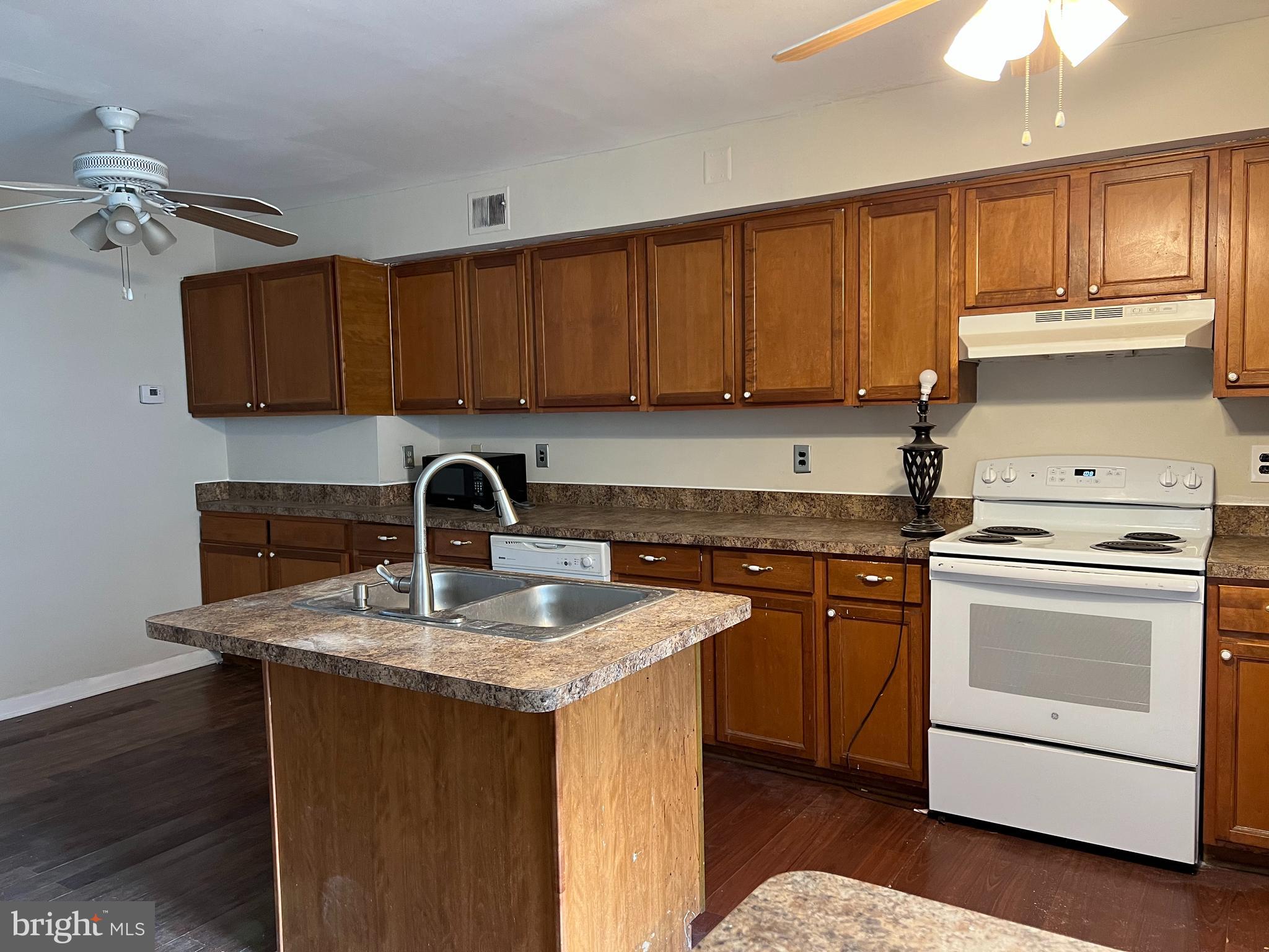 9580 Canterbury Riding, Unit 210 Laurel, MD 20723 - Photo 4 of 10 a kitchen with stainless steel appliances granite countertop a sink stove and refrigerator