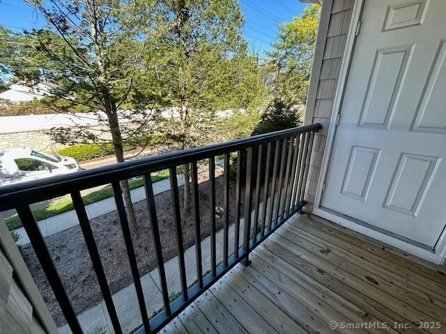 a view of balcony with wooden floor