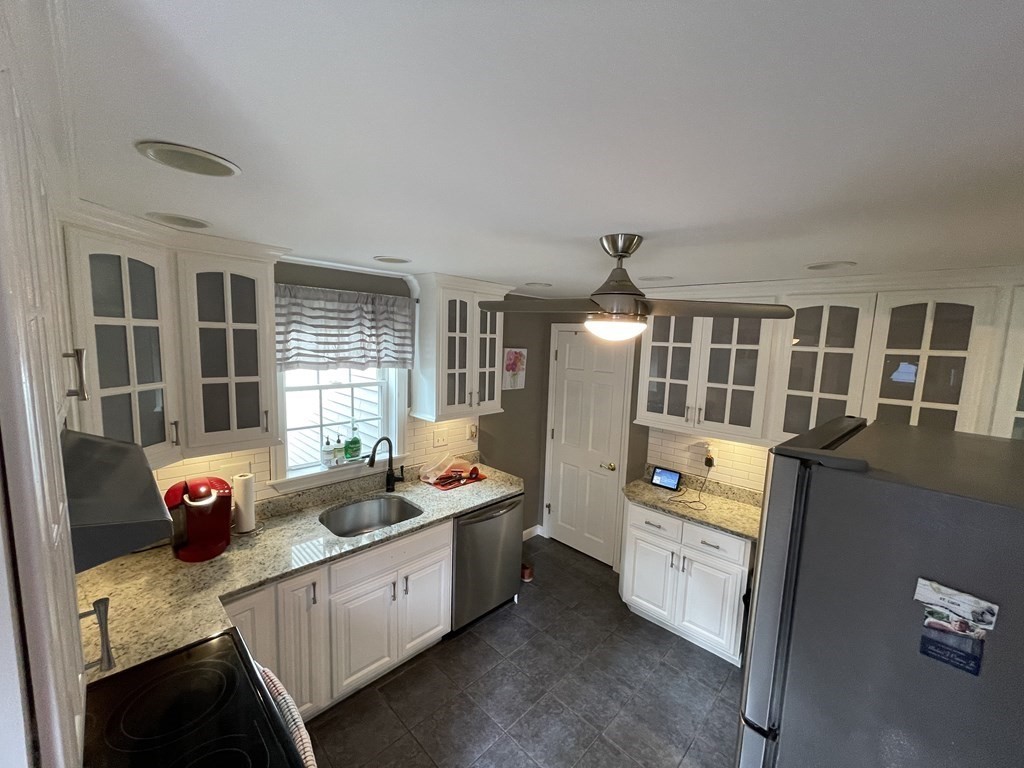 22 Westbrook Road Worcester, MA 01602 - Photo 15 of 39 a kitchen that has a lot of cabinets a sink and a wooden floor