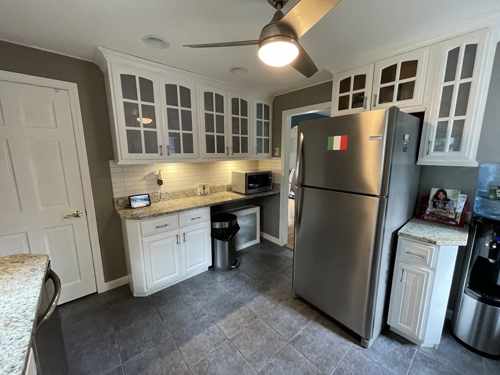 22 Westbrook Road Worcester, MA 01602 - Photo 17 of 39 a kitchen with refrigerator a stove and cabinets