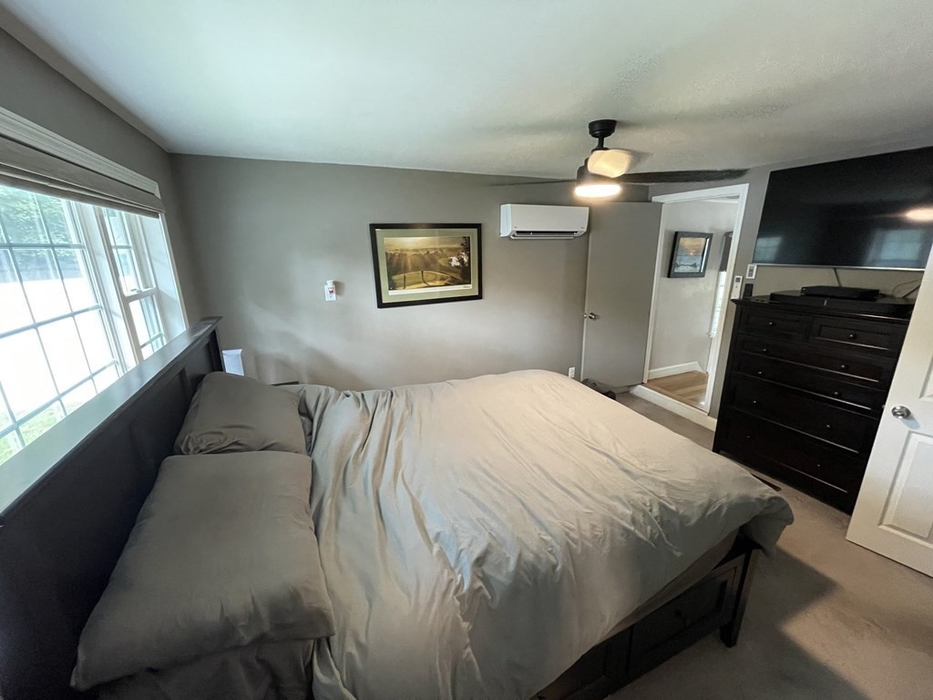 22 Westbrook Road Worcester, MA 01602 - Photo 24 of 39 a bedroom with a bed and a flat screen tv