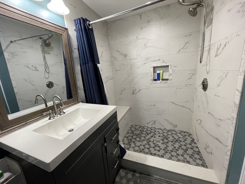 22 Westbrook Road Worcester, MA 01602 - Photo 27 of 39 a bathroom with a sink mirror and shower