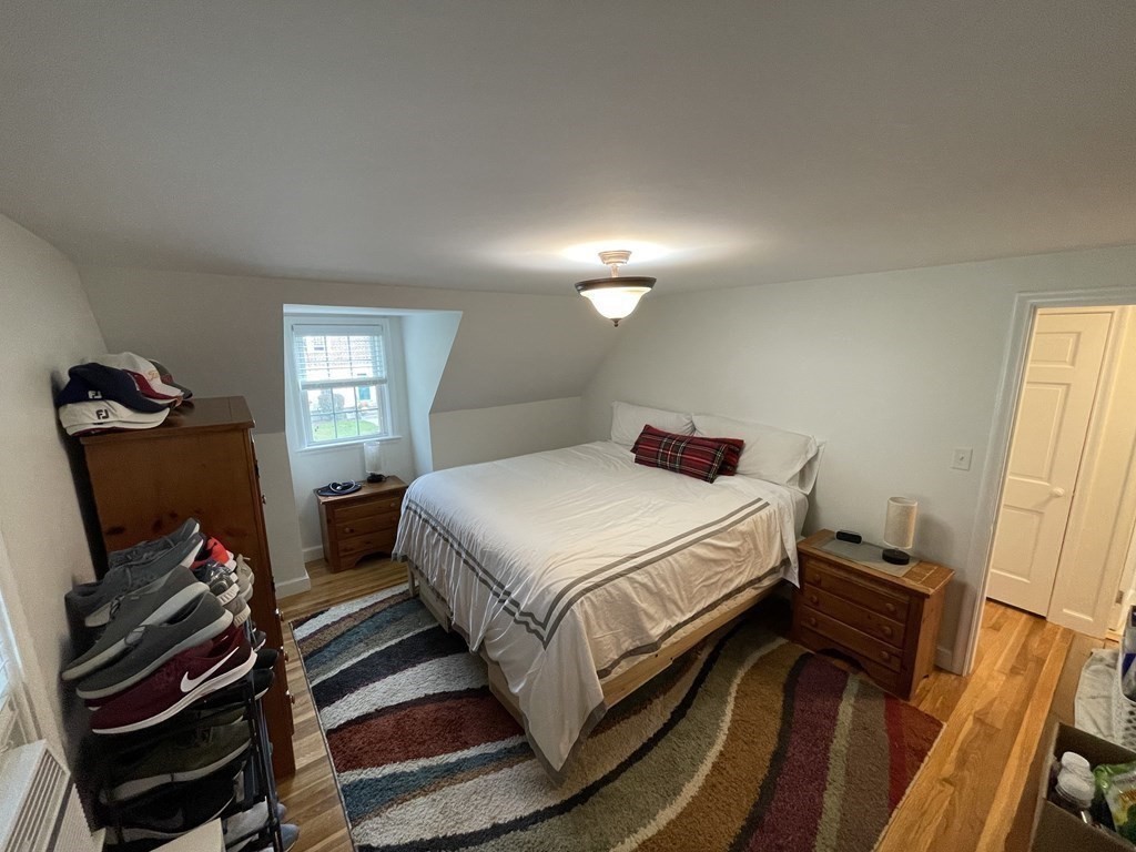 22 Westbrook Road Worcester, MA 01602 - Photo 30 of 39 a bedroom with a bed and a flat tv screen on a dresser