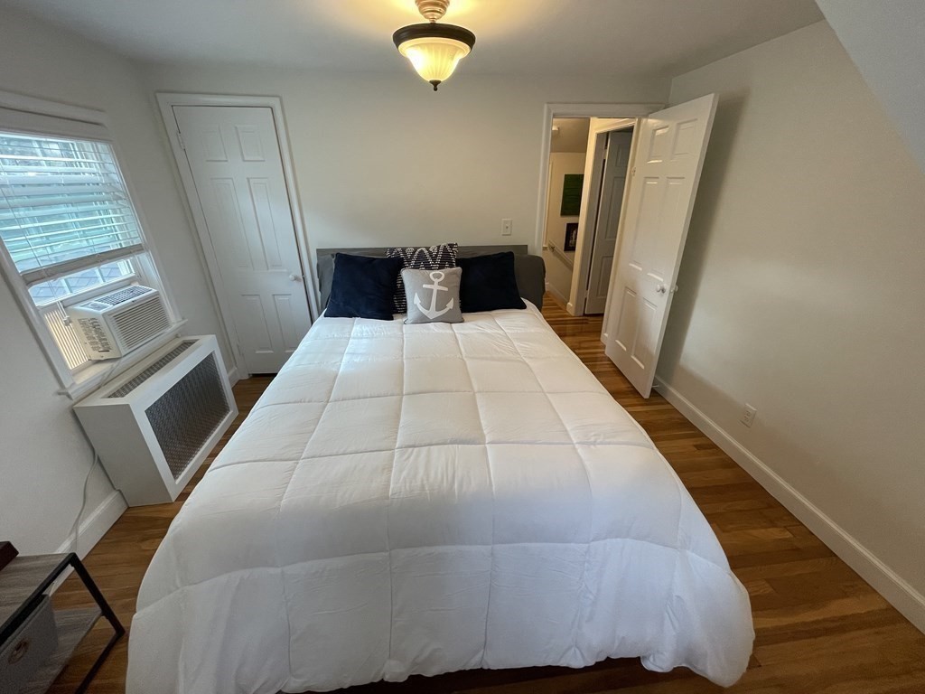 22 Westbrook Road Worcester, MA 01602 - Photo 32 of 39 a bedroom with a bed and wooden floor