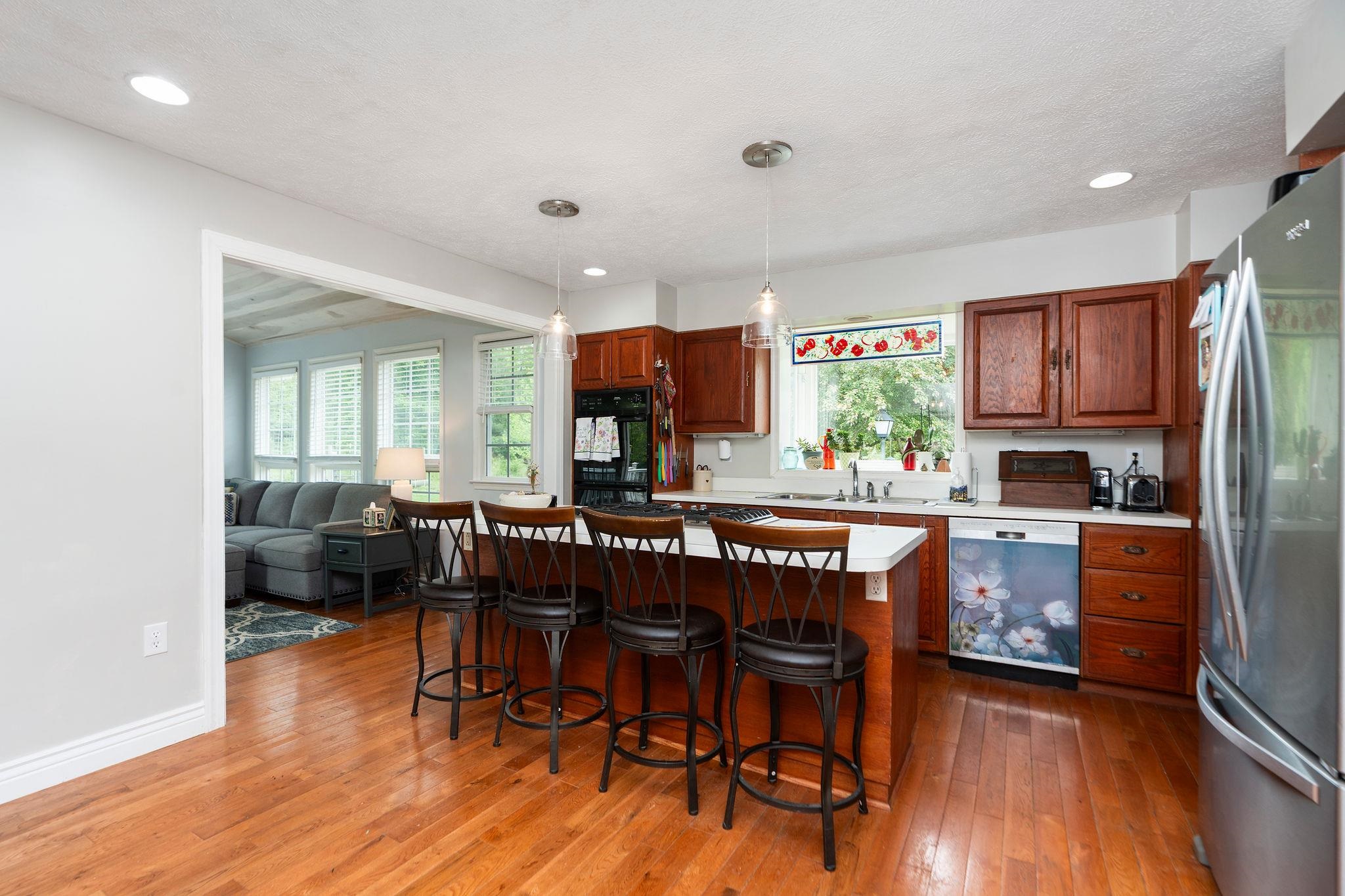 516 Estaline Valley Road Craigsville, VA 24430 - Photo 6 of 75 a kitchen with stainless steel appliances granite countertop a table chairs and a refrigerator