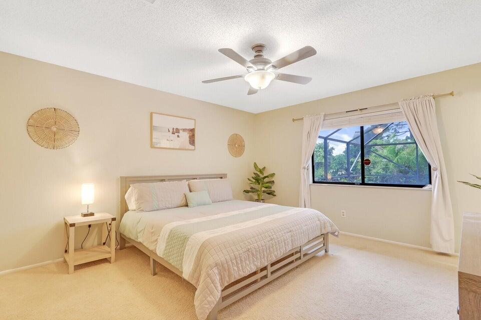 1258 Southeast Rickenbacker Terrace Port St. Lucie, FL 34952 - Photo 13 of 29 a bedroom with a large bed and a window
