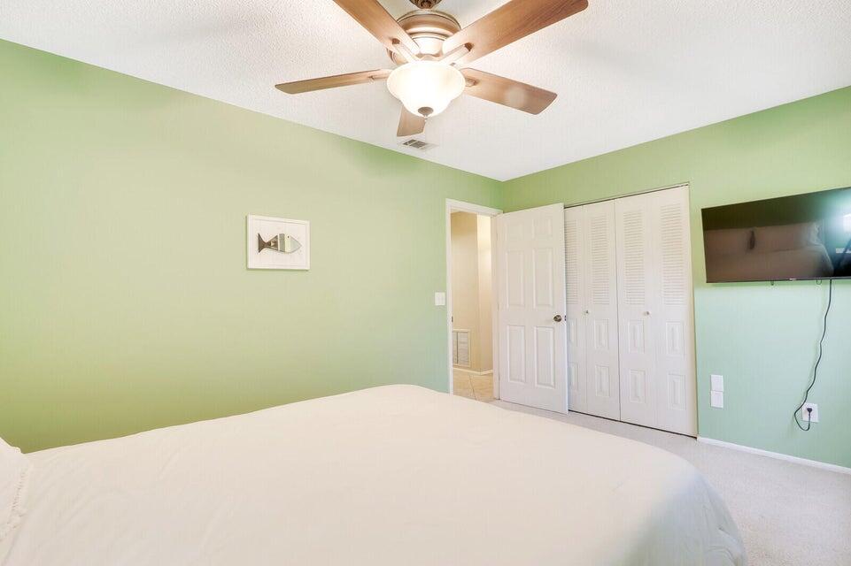 1258 Southeast Rickenbacker Terrace Port St. Lucie, FL 34952 - Photo 18 of 29 a bedroom with a bed and a ceiling fan