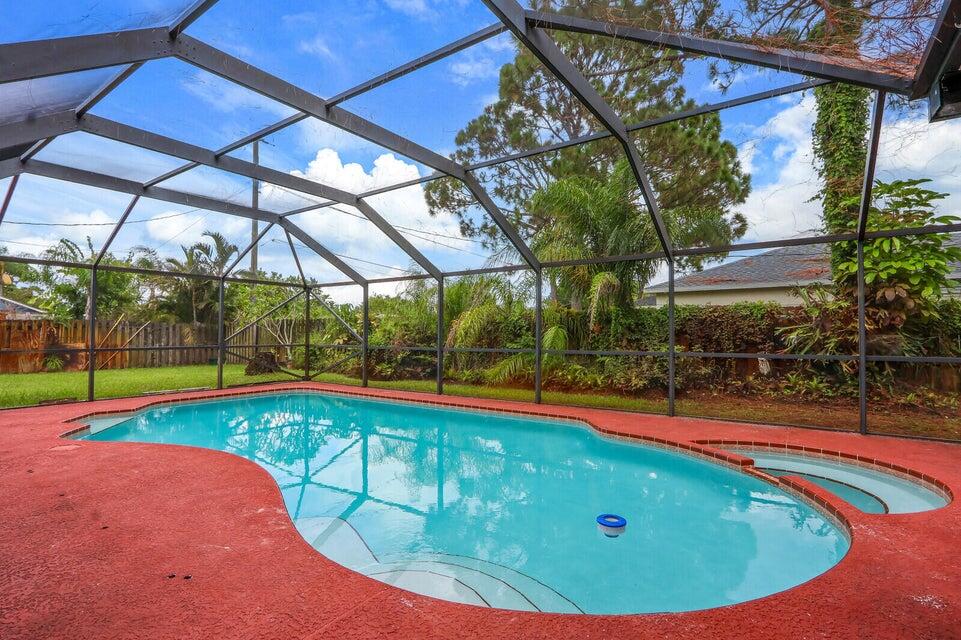 1258 Southeast Rickenbacker Terrace Port St. Lucie, FL 34952 - Photo 25 of 29 a view of a backyard with a swimming pool
