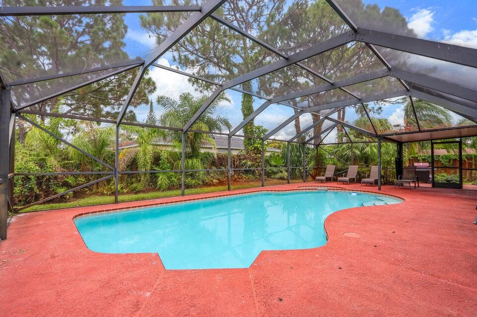 1258 Southeast Rickenbacker Terrace Port St. Lucie, FL 34952 - Photo 26 of 29 a view of a swimming pool with a patio and a yard