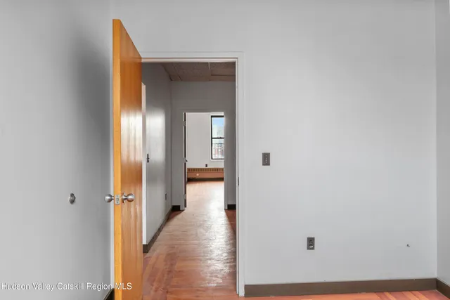 a view of entryway with wooden floor and stairs
