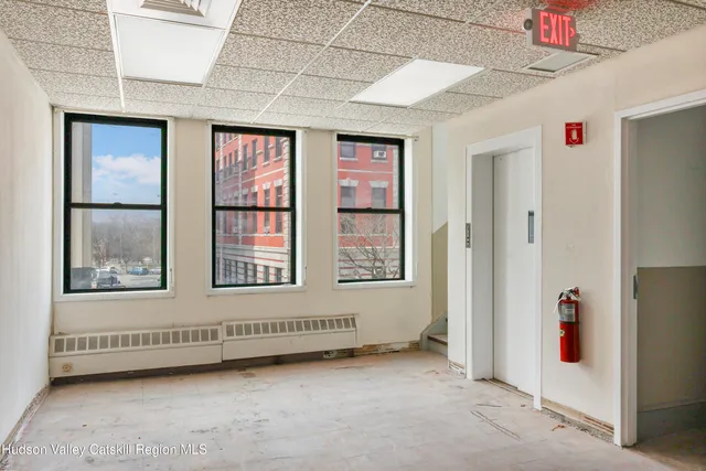 a view of a hallway with wooden walls
