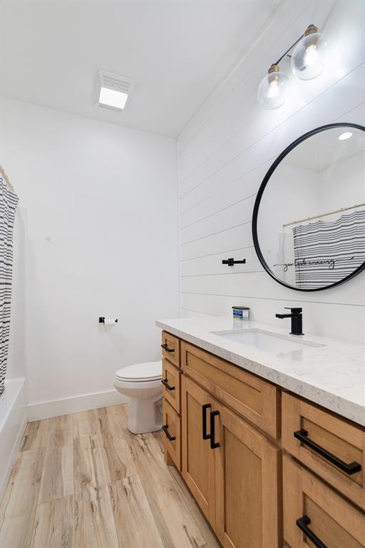 147 County Road Powderly, TX 75473 - Photo 10 of 14 a bathroom with a toilet a sink and a mirror