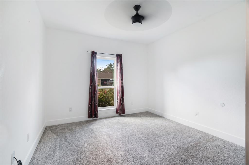 147 County Road Powderly, TX 75473 - Photo 11 of 14 an empty room with a empty space and windows