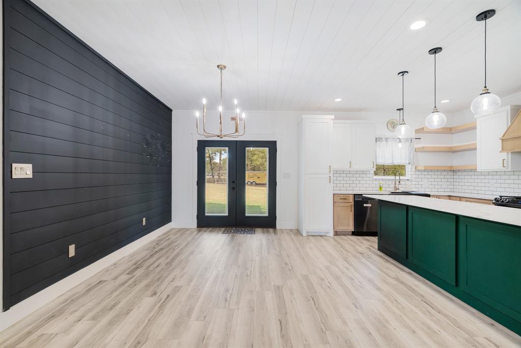 147 County Road Powderly, TX 75473 - Photo 6 of 14 a view of a kitchen with kitchen island wooden floor stainless steel appliances and cabinets