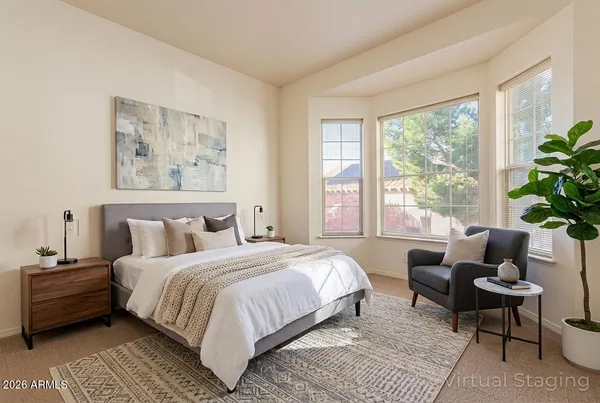 a bedroom with a bed and a couch