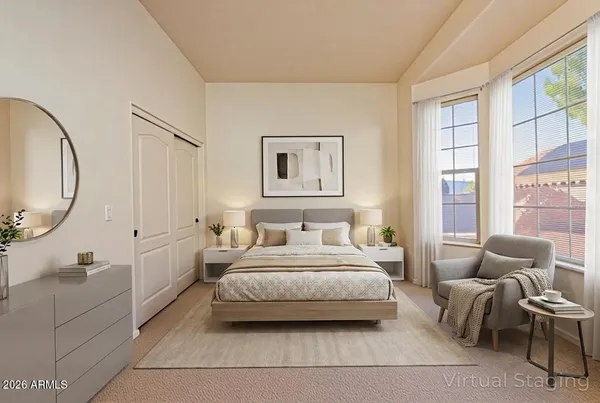 a spacious bedroom with a bed a couch and a large window