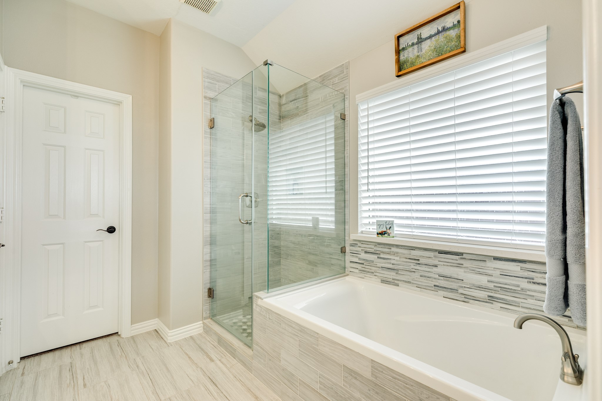 13808 Stark Bridge Lane Rosharon, TX 77583 - Photo 18 of 39 Modern primary bathroom featuring a spacious glass walk-in shower with newly installed designer tile flooring and matching wall accents that seamlessly complement the backsplash of the soaking tub.