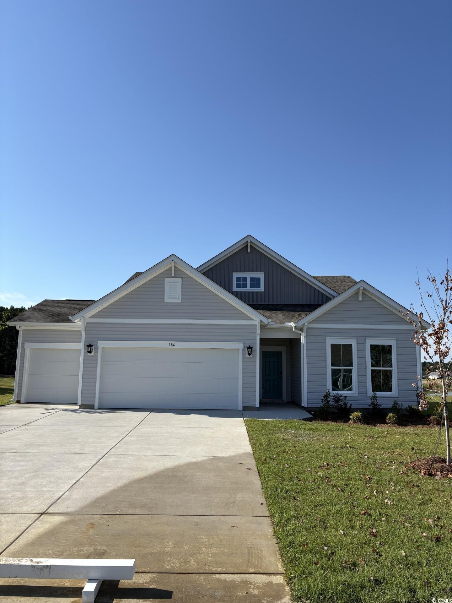 186 Glengrove Lane Murrells Inlet, SC 29576 - Photo 3 of 36 View of front of home featuring driveway, a front lawn, board and batten siding, an attached garage, and roof with shingles