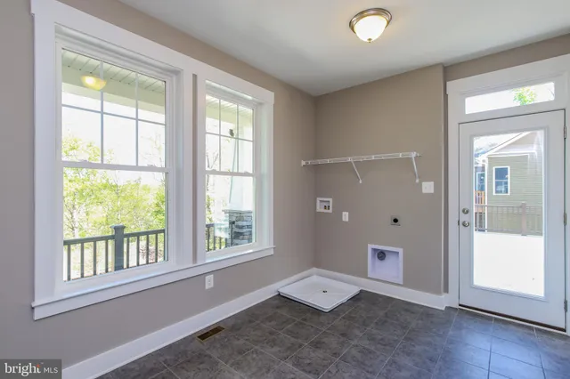 an empty room with windows and closet