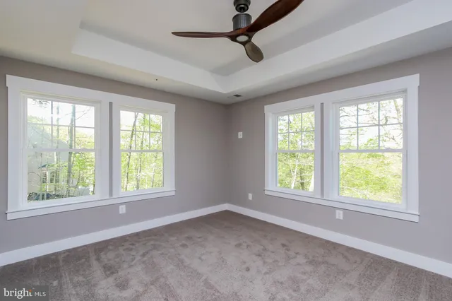 an empty room with windows and closet