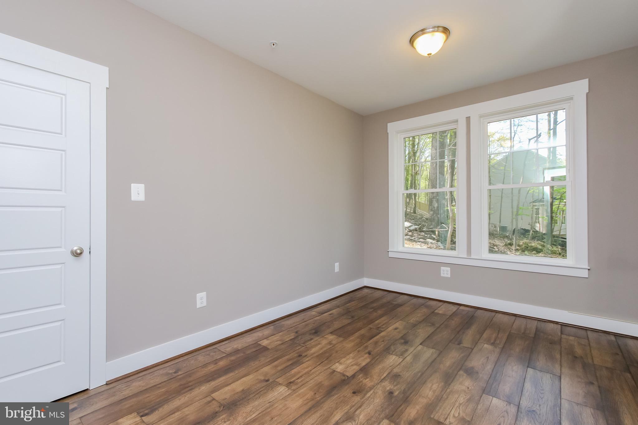 6346 Zittlestown Road Boonsboro, MD 21713 - Photo 6 of 27 an empty room with wooden floor and windows