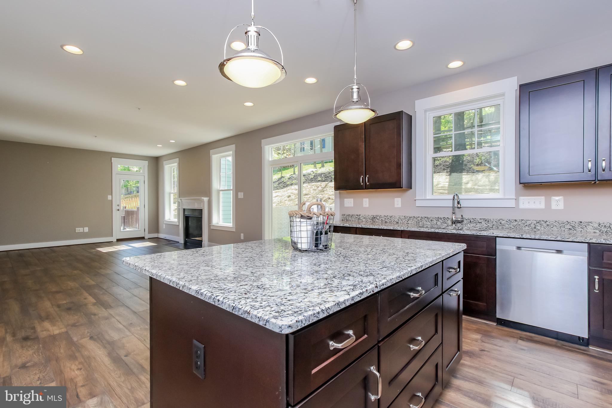 6346 Zittlestown Road Boonsboro, MD 21713 - Photo 8 of 27 a kitchen with granite countertop kitchen island a sink dishwasher a dining table and chairs with wooden floor