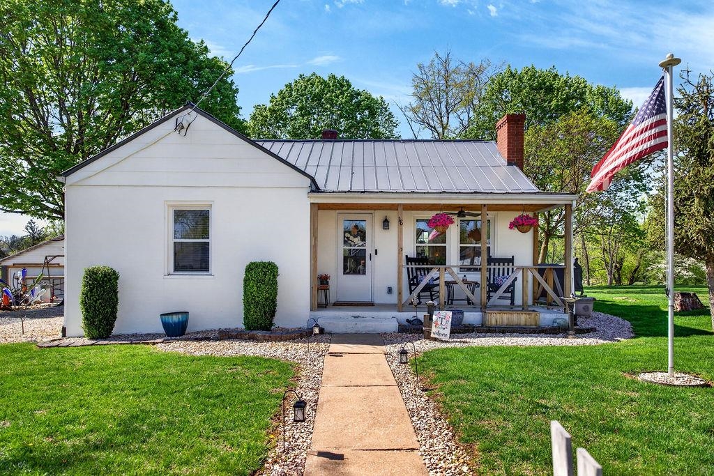 a view of a house with backyard and a patio