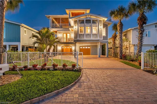 a front view of a building with a garden