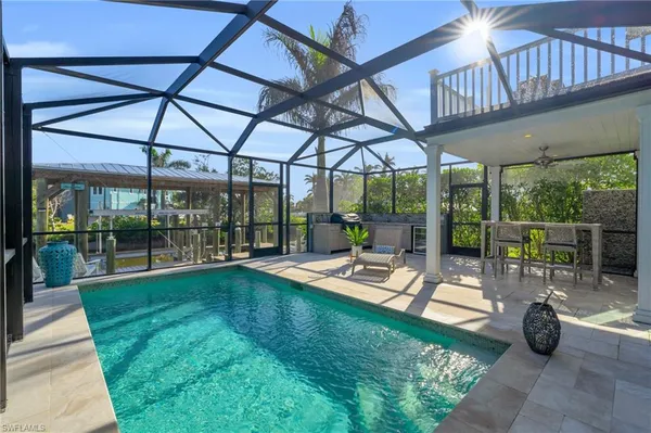 a view of swimming pool with outdoor seating