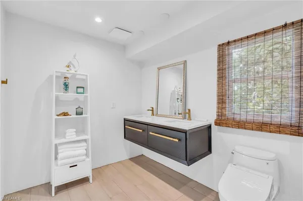 a bathroom with a sink toilet a mirror and shower