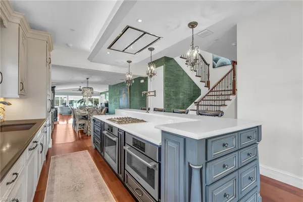 a kitchen with stainless steel appliances granite countertop a sink and cabinets