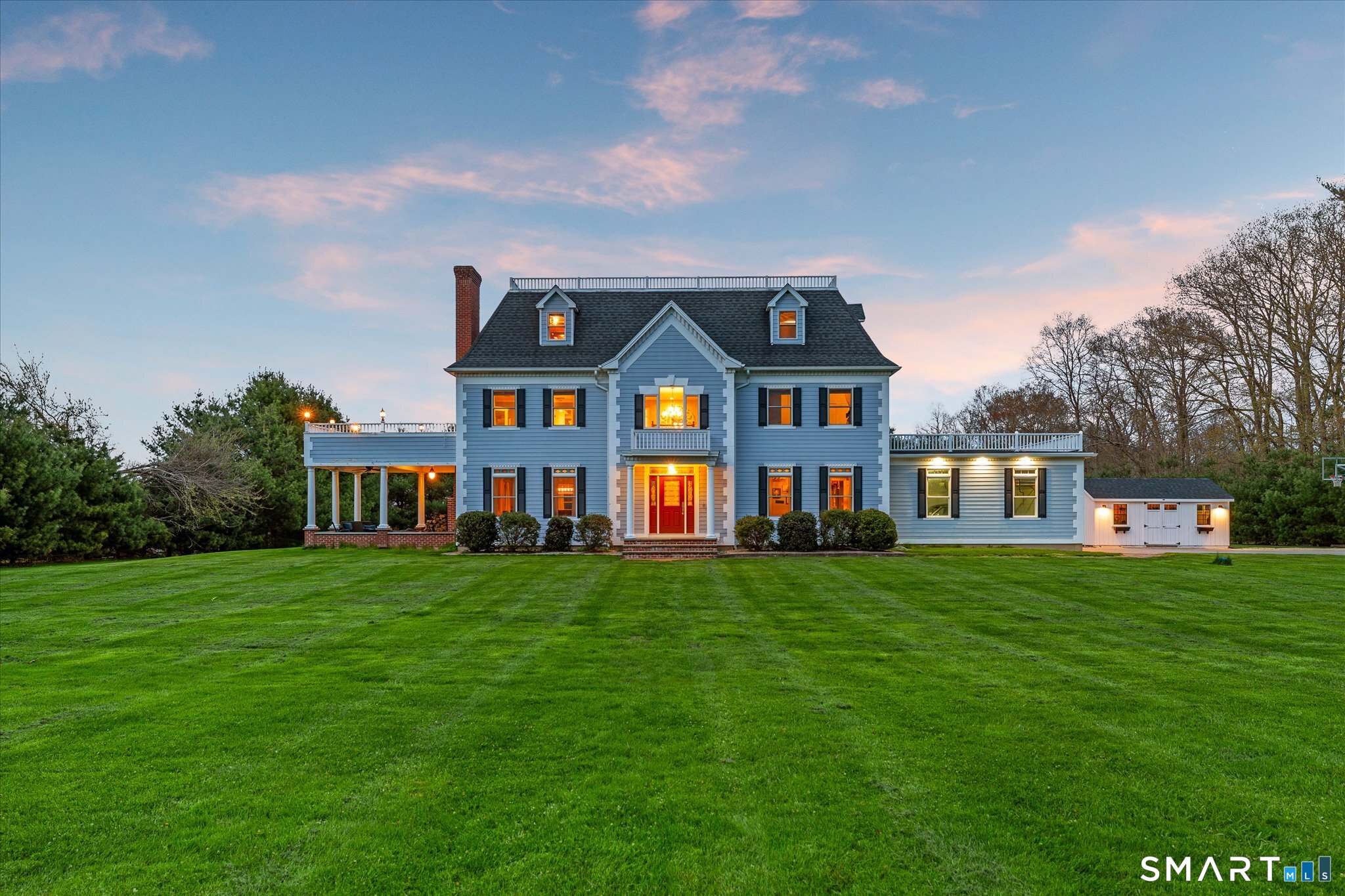 a front view of a house with a garden
