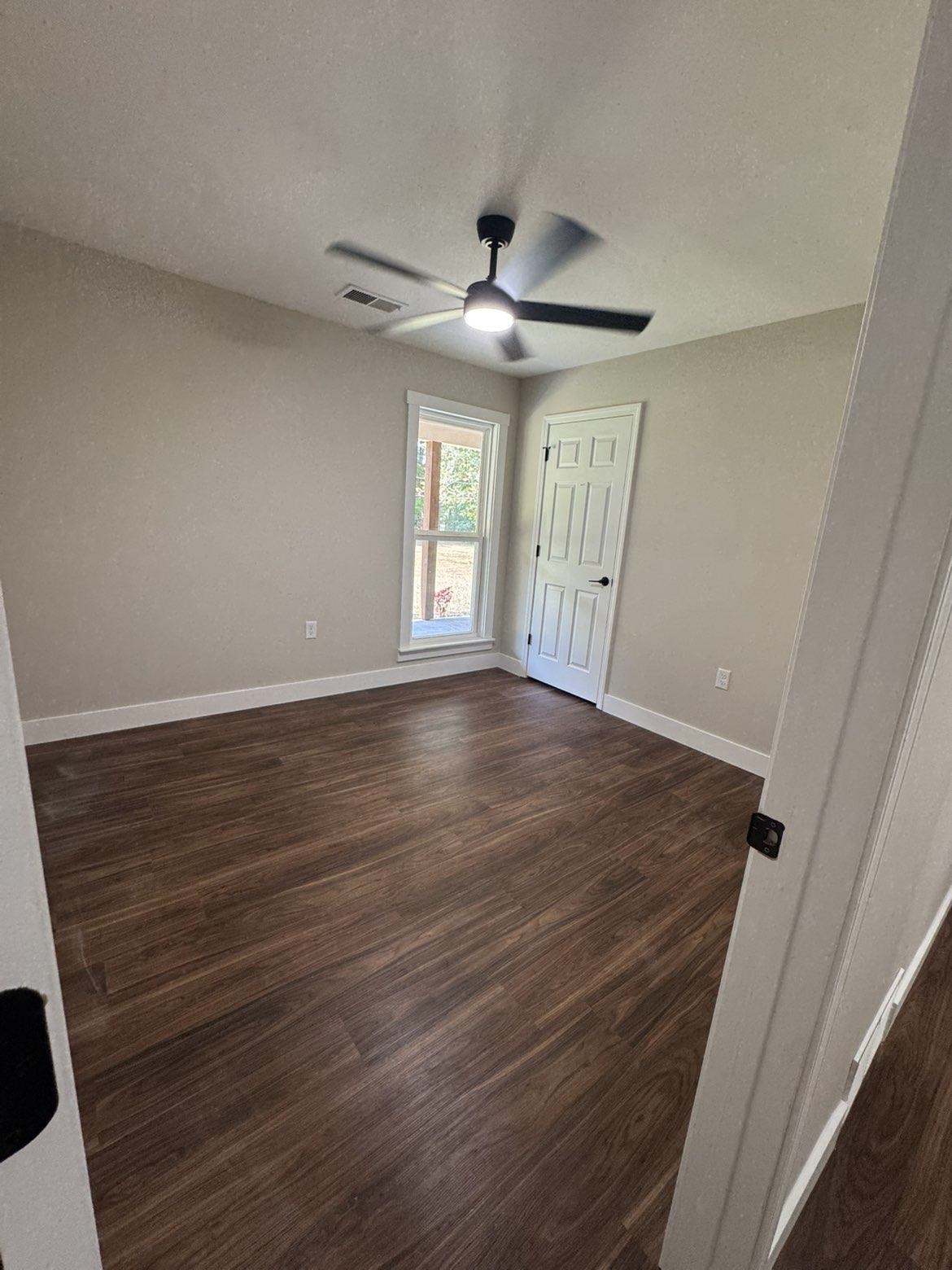 3540 Portersville Road Atoka, TN 38004 - Photo 17 of 37 Wood-finish flooring, neutral wall paint, ceiling fan with integrated lighting, and white trim throughout