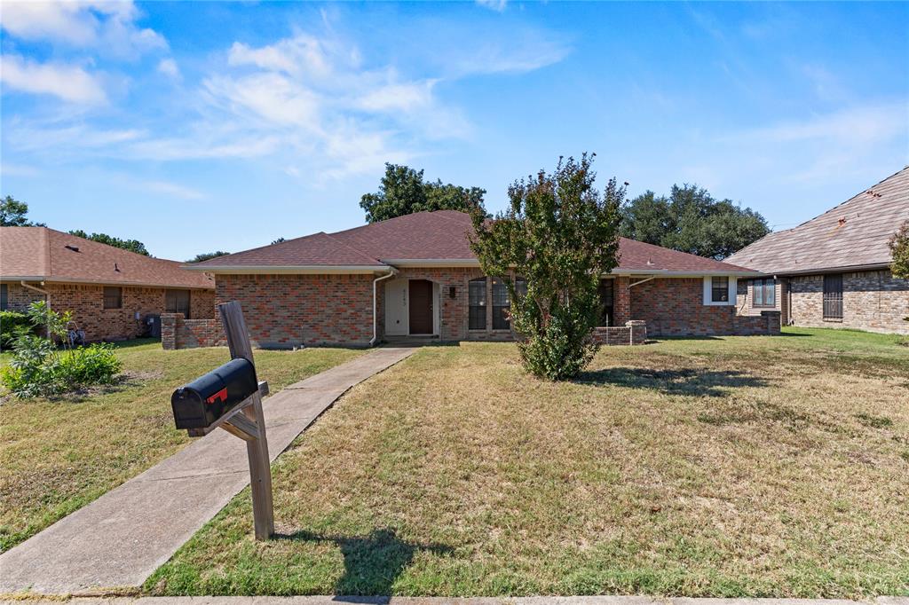 4243 Blackheath Road Dallas, TX 75227 - Photo 1 of 1 Ranch-style house with a front lawn, a shingled roof, and brick siding