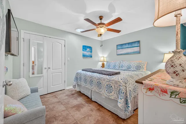 a bedroom with a large bed and a chandelier