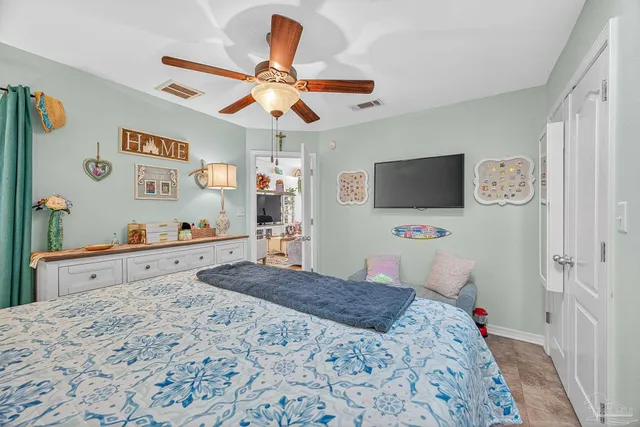 a bedroom with a bed mirror and a window