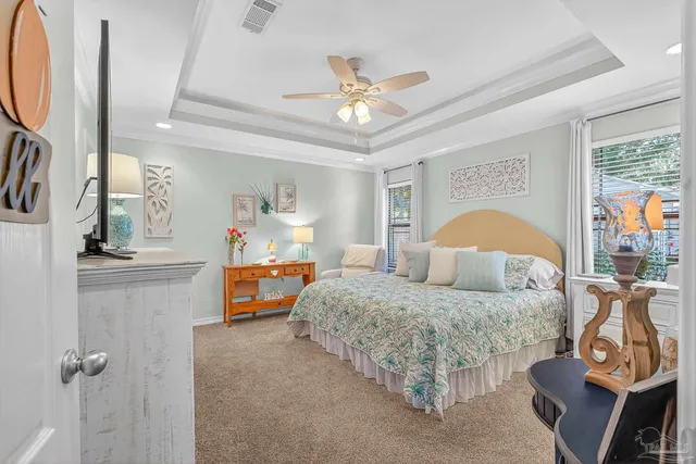 a bedroom with a large bed and a chandelier