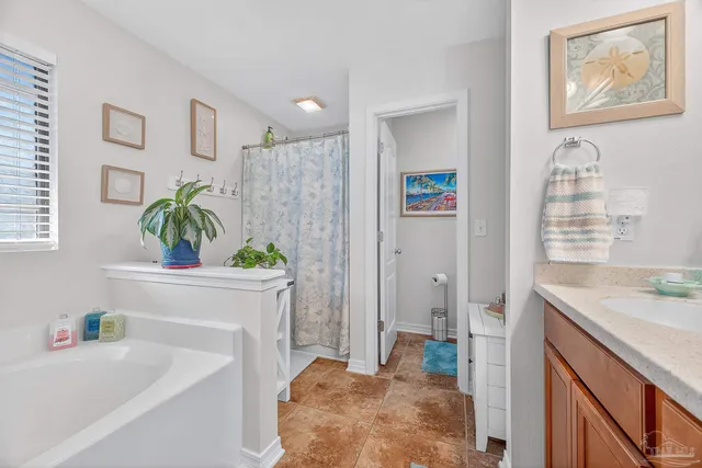 a spacious bathroom with a tub sink and mirror