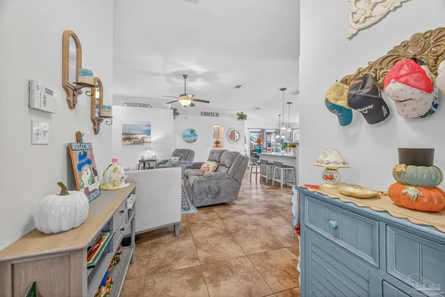 a kitchen with stainless steel appliances kitchen island granite countertop a table chairs and a refrigerator