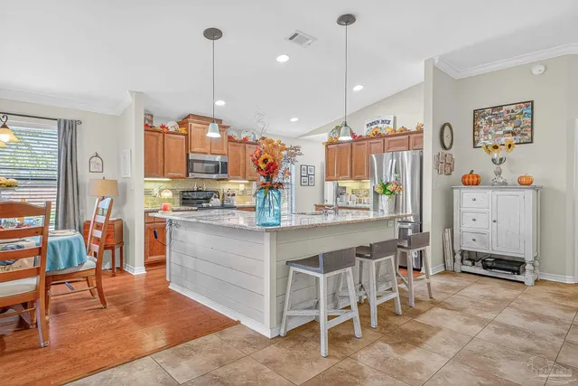 a kitchen with stainless steel appliances granite countertop a stove and cabinets
