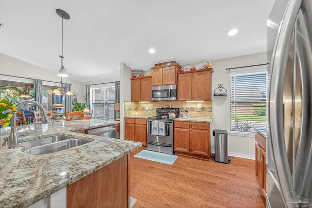 a kitchen kitchen with stainless steel appliances granite countertop a sink a counter space and cabinets