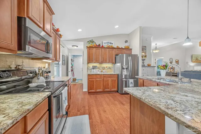 a living room with furniture a clock and a window
